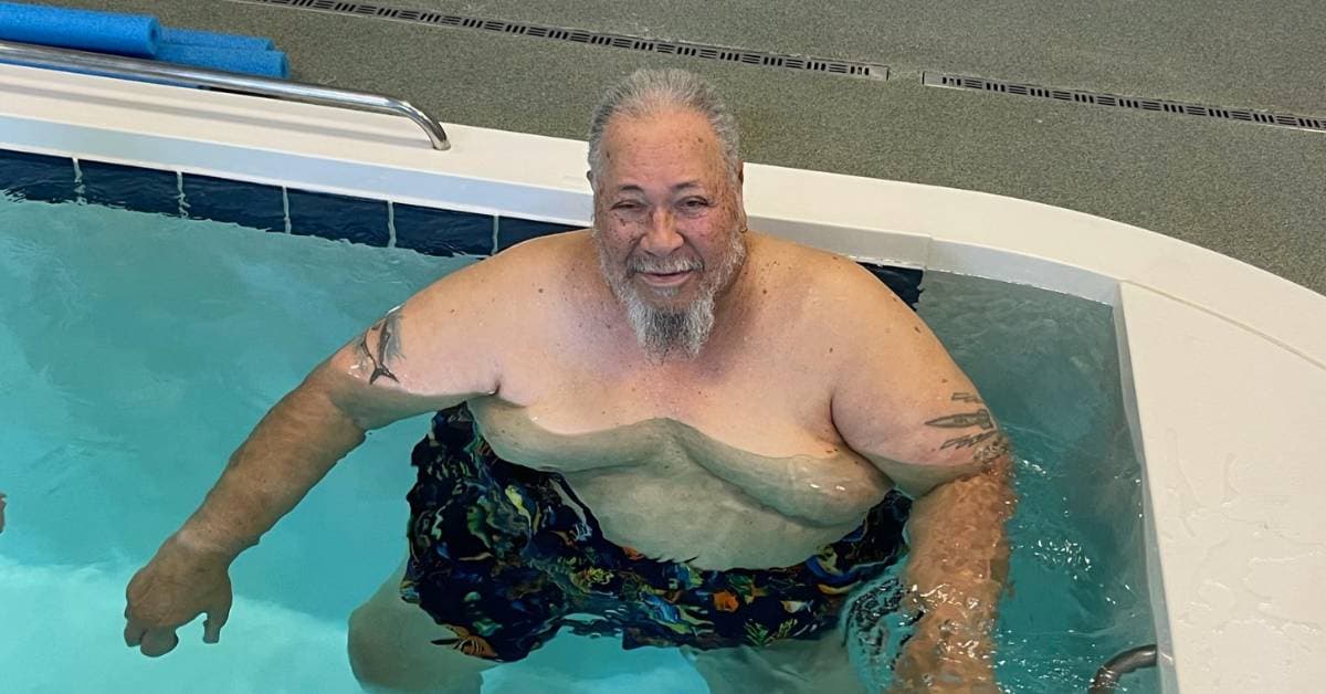 Patient walking in SwimEx therapy pool during rehabilitation