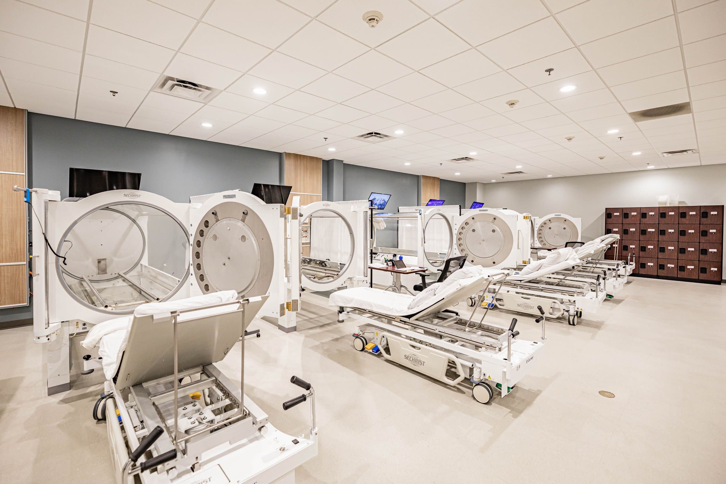 Row of medical-grade HBOT chambers in a modern treatment facility