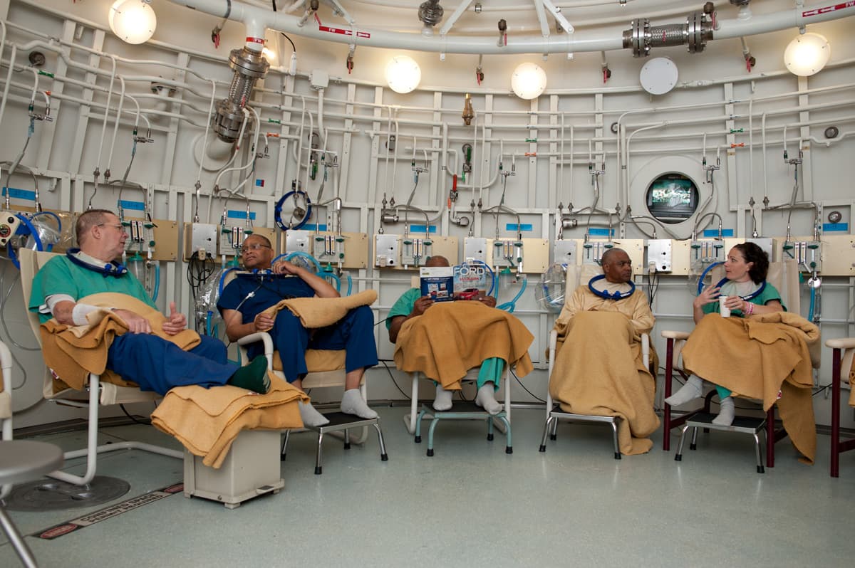Veterans receiving hyperbaric oxygen therapy inside a multiplace HBOT chamber